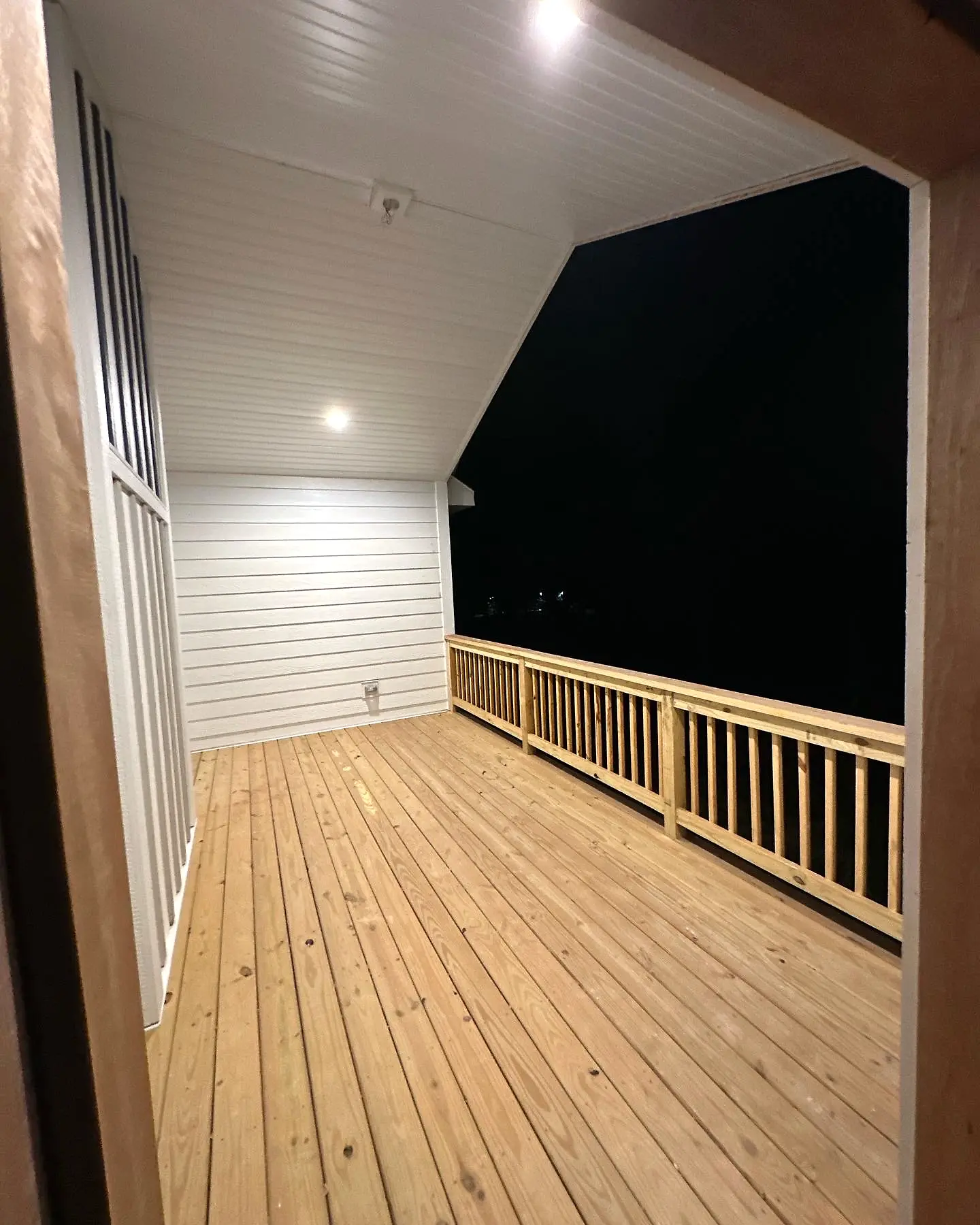 Covered porch with wood decking and railing