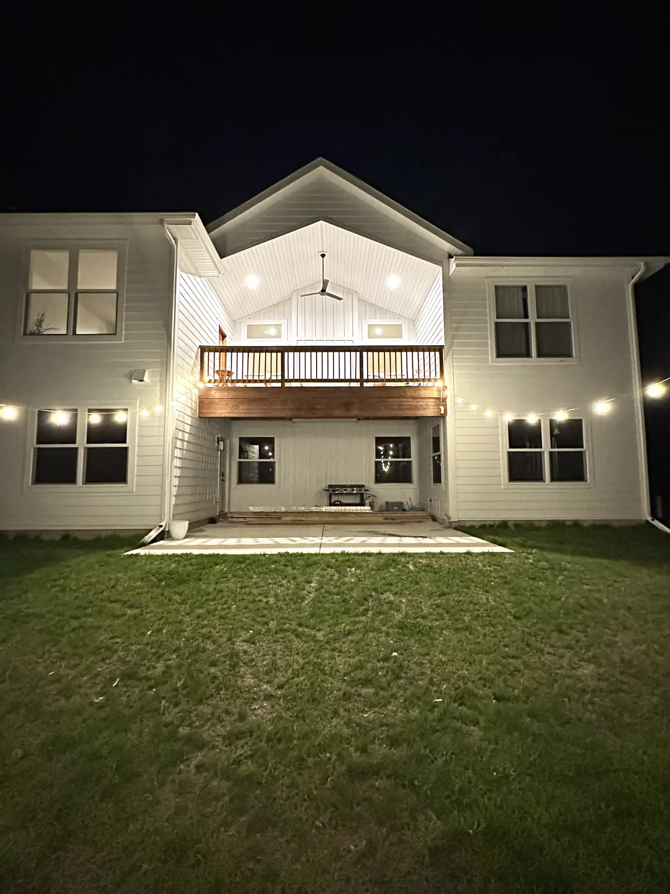 Rear elevation with covered upper deck and exterior lighting